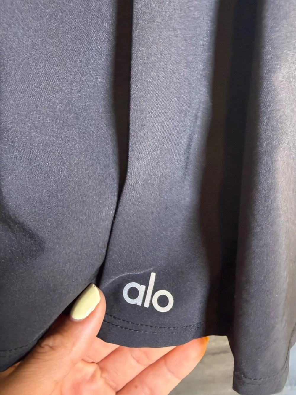 ALO Yoga black athletic skort with reflective logo